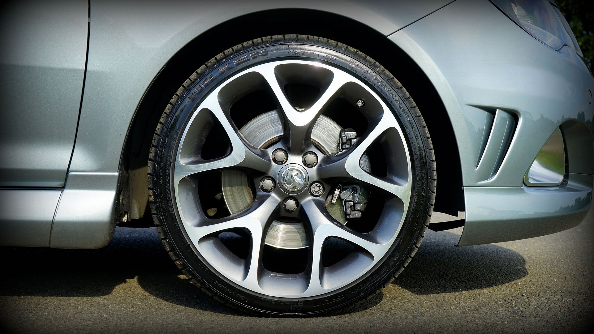 Detailed view of a silver car wheel, showcasing the alloy rim and tire on a Vauxhall model.